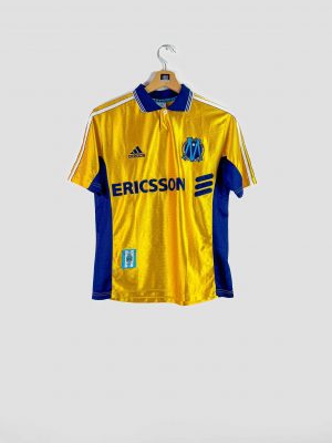 Maillot domicile Olympique de Marseille 1998-1999 Adidas, coloris jaune et bleu avec sponsor Ericsson.