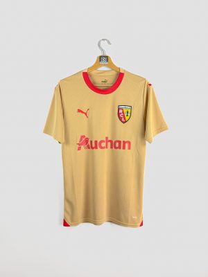 Vue de face du maillot extérieur 2023-2024 du RC Lens, coloris or avec le logo Puma et le sponsor Auchan au centre.