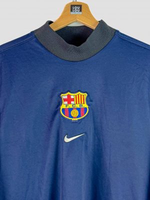 Maillot de gardien du FC Barcelone 1998-1999 signé Nike, couleur bleu marine avec col noir, écusson FCB brodé sur la poitrine et patch LFP sur la manche.